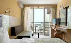 Et hotelværelse med havudsigt og altan. (AI-genereret tekst)