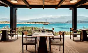 Udendørs servering med udsigt over havet og bjergene. (AI-genereret tekst)