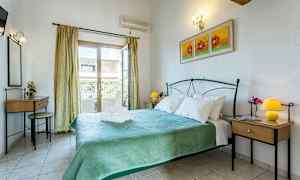 Et soveværelse med en dobbeltseng, to natborde med lamper og en altandør. Væggen er udsmykket med et maleri. (AI-genereret tekst)