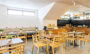 En moderne spisestue med træstole og borde samt dekorationer. (AI-genereret tekst)