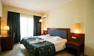 Billede af et hotelværelse med en dobbeltseng, skrivebord og natbord. (AI-genereret tekst)