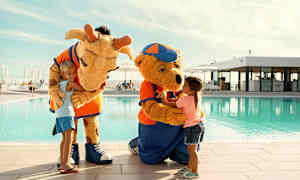 To figurer i dyrekostumer ved en pool, der interagerer med børn. (AI-genereret tekst)