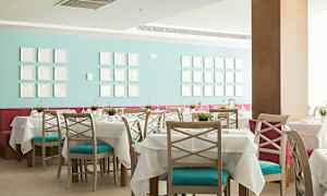 Restaurant med dækkede borde og farverigt interiør. (AI-genereret tekst)