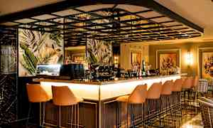 En elegant bar med siddepladser og eksotiske mønstre på væggene. (AI-genereret tekst)