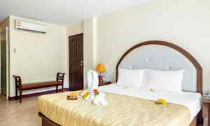 Hotelværelse med en stor seng og udsmykket håndklæde. (AI-genereret tekst)