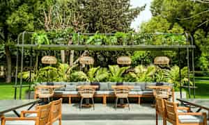 Udendørs område med siddepladser, sofaer, stole og grønne omgivelser. (AI-genereret tekst)