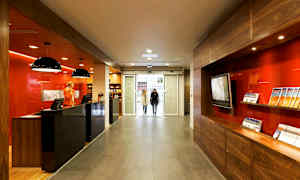 Reception med moderne indretning og informationsbrochurer, beliggende nær en glassentré. (AI-genereret tekst)