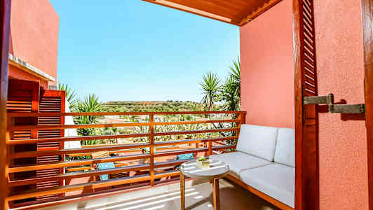 Udendørsområde med siddeplads og bord med solrig udsigt. (AI-genereret tekst)