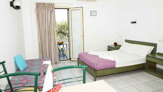 Et hotelværelse med en dobbeltseng, en sofa, et bord med stole og en altan med udsigt. (AI-genereret tekst)