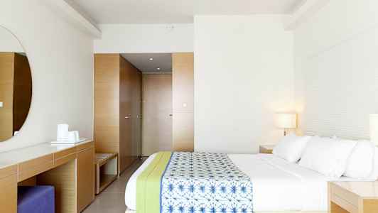 Et moderne hotelværelse med en rummelig seng og minimalistisk indretning. (AI-genereret tekst)