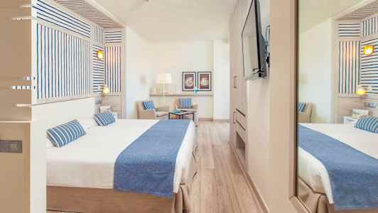 Hotelværelse med dobbeltseng og stol, indrettet i en lys og moderne stil. (AI-genereret tekst)