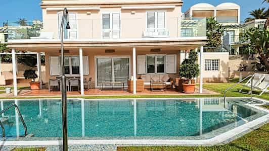 En villa med to etager, solterrasse og pool. (AI-genereret tekst)