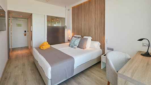 Et hotelværelse med en dobbeltseng, skrivebord og trædetaljer. (AI-genereret tekst)