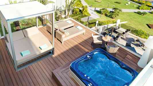 Udendørsområde med spabad, liggestole og siddegruppe. (AI-genereret tekst)