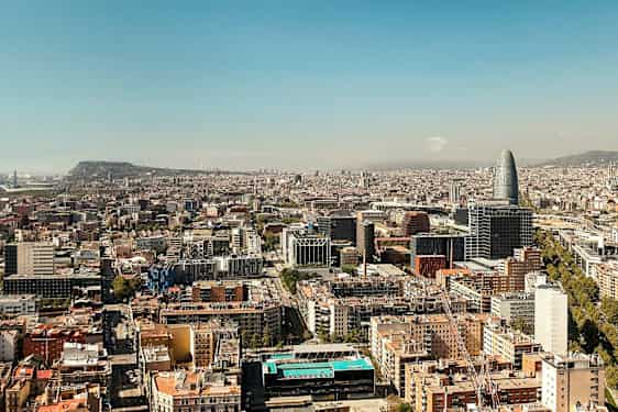 Udsigt over en by med flere bygninger og en unik høj bygning synlig. (AI-genereret tekst)