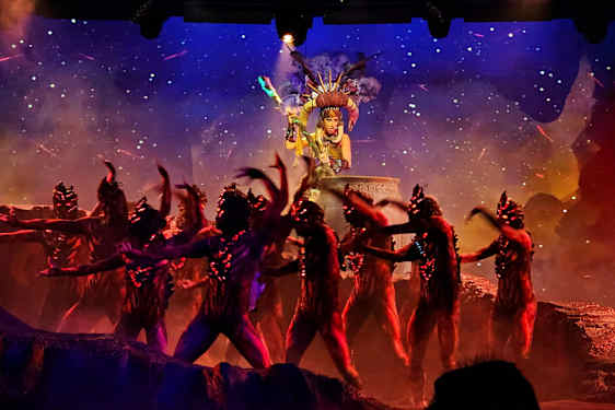 En sceneoptræden med dansere i kostumer foran en dekoreret baggrund. (AI-genereret tekst)