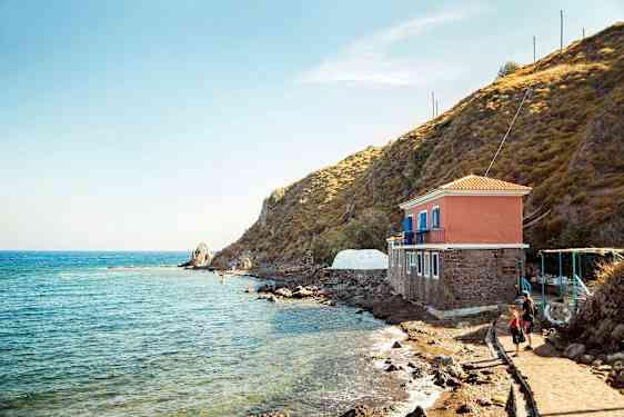 Hus ved havet ved siden af en klippe. (AI-genereret tekst)