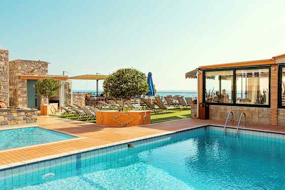 Billede af en udendørs pool ved siden af en solterrasse med solsenge og havudsigt. (AI-genereret tekst)