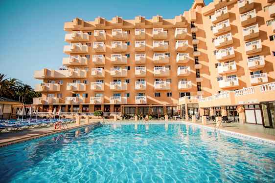 Bygning med flere altaner og en stor pool foran. (AI-genereret tekst)