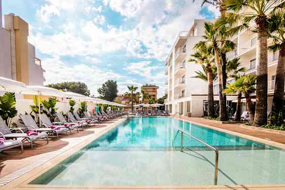 Swimmingpool ved hotel med liggestole og parasoller. (AI-genereret tekst)