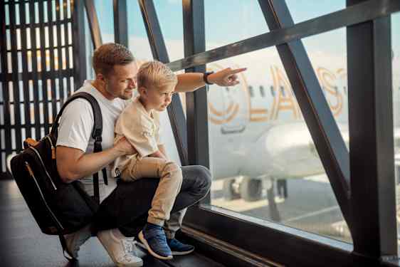 Far og søn ser på fly