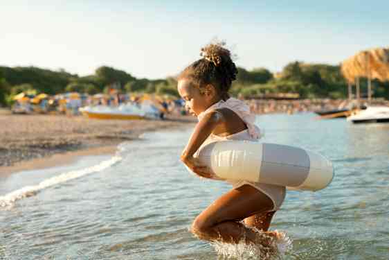 Pige bader på stranden på påskeferie med børn