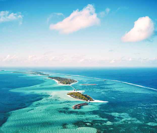 Luftfoto af tropiske øer omgivet af turkisblåt hav. (AI-genereret tekst)