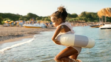 Pige bader på stranden på påskeferie med børn