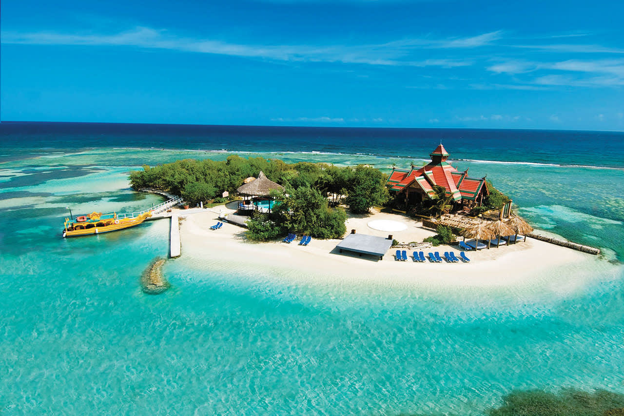 Hotellets egen ø med sandstrand, liggestole og restaurant