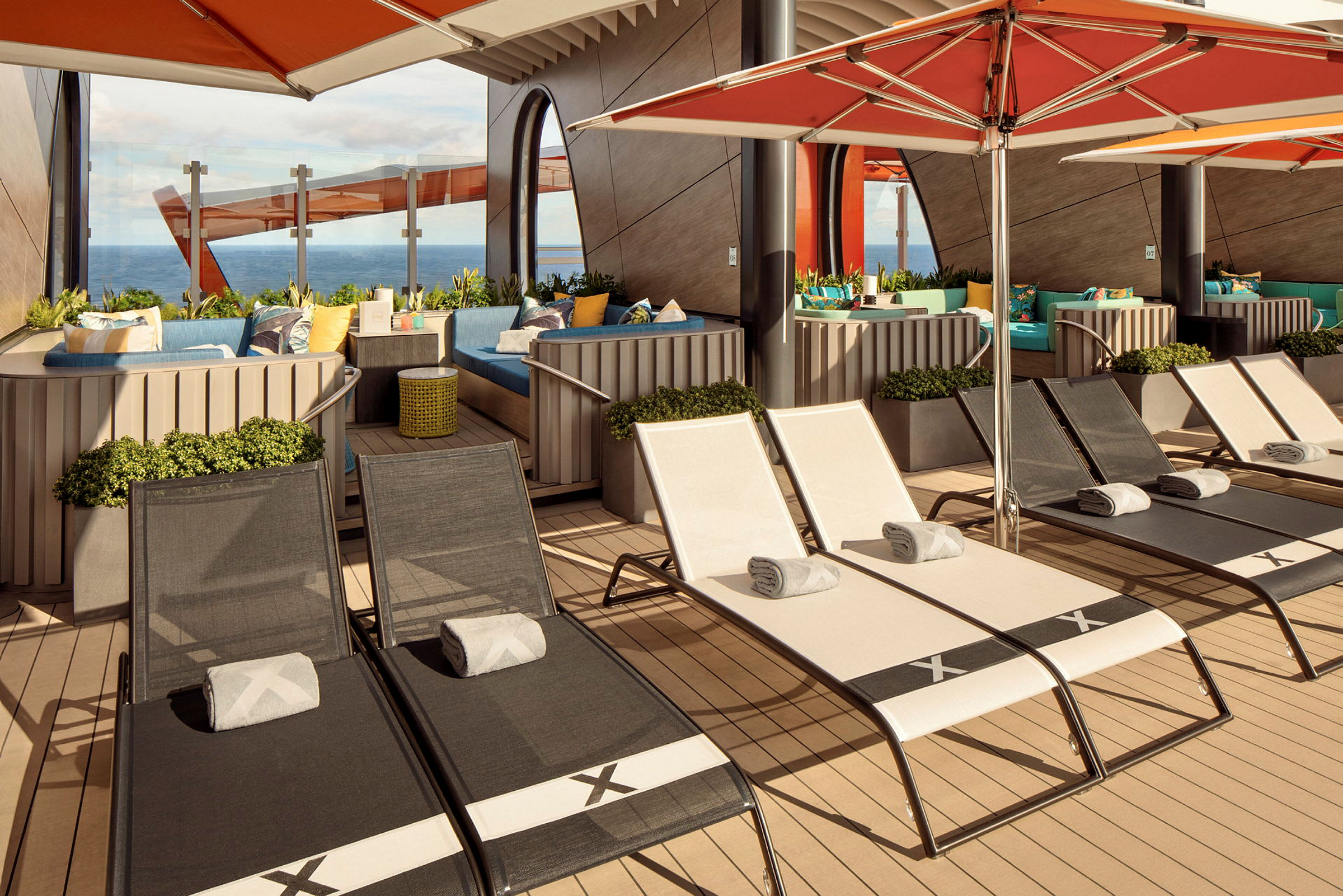 Billede af en solterrasse med liggestole, parasoller og siddeområder med havudsigt. (AI-genereret tekst)