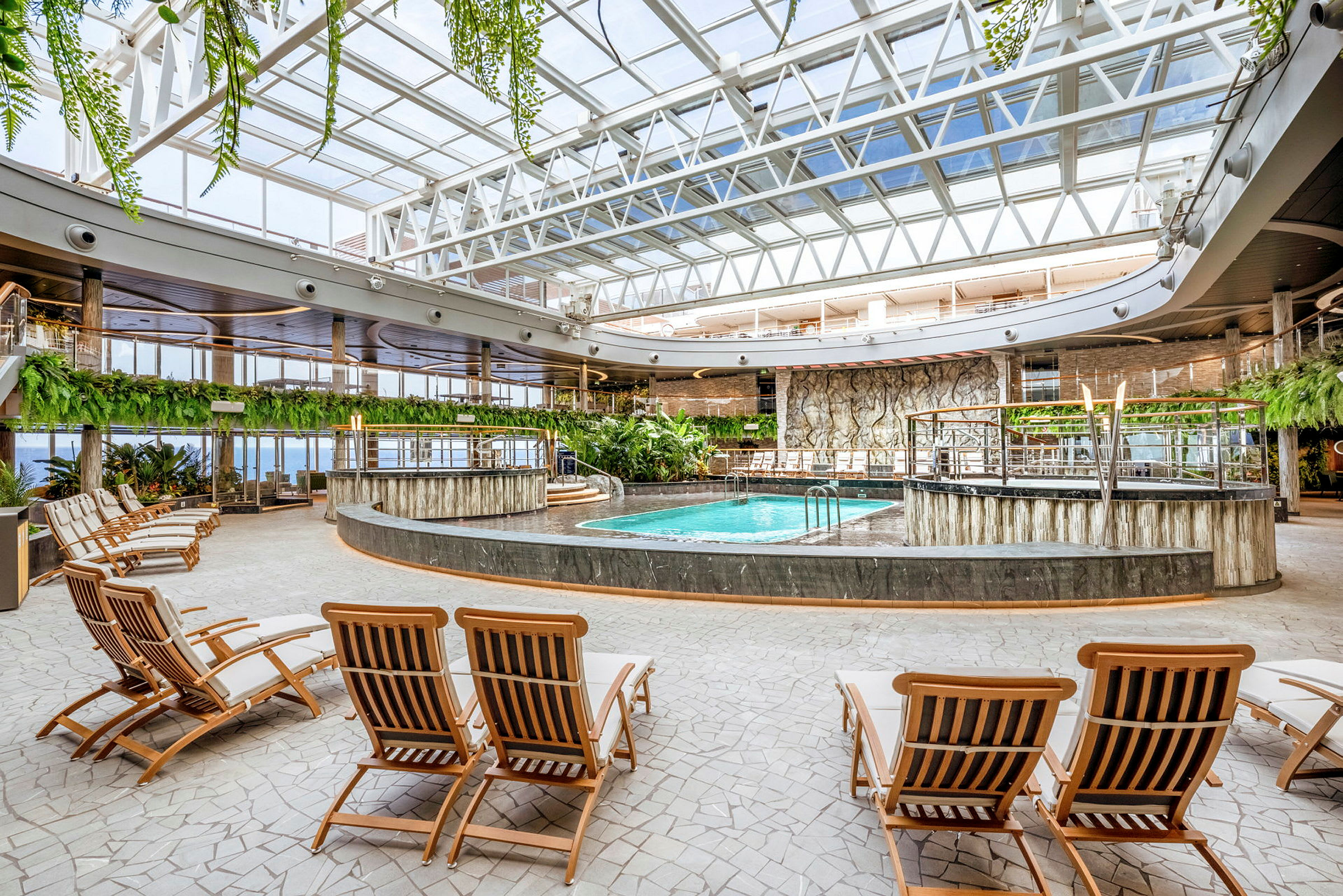 Indendørs poolområde med liggestole og planteudsmykning. (AI-genereret tekst)