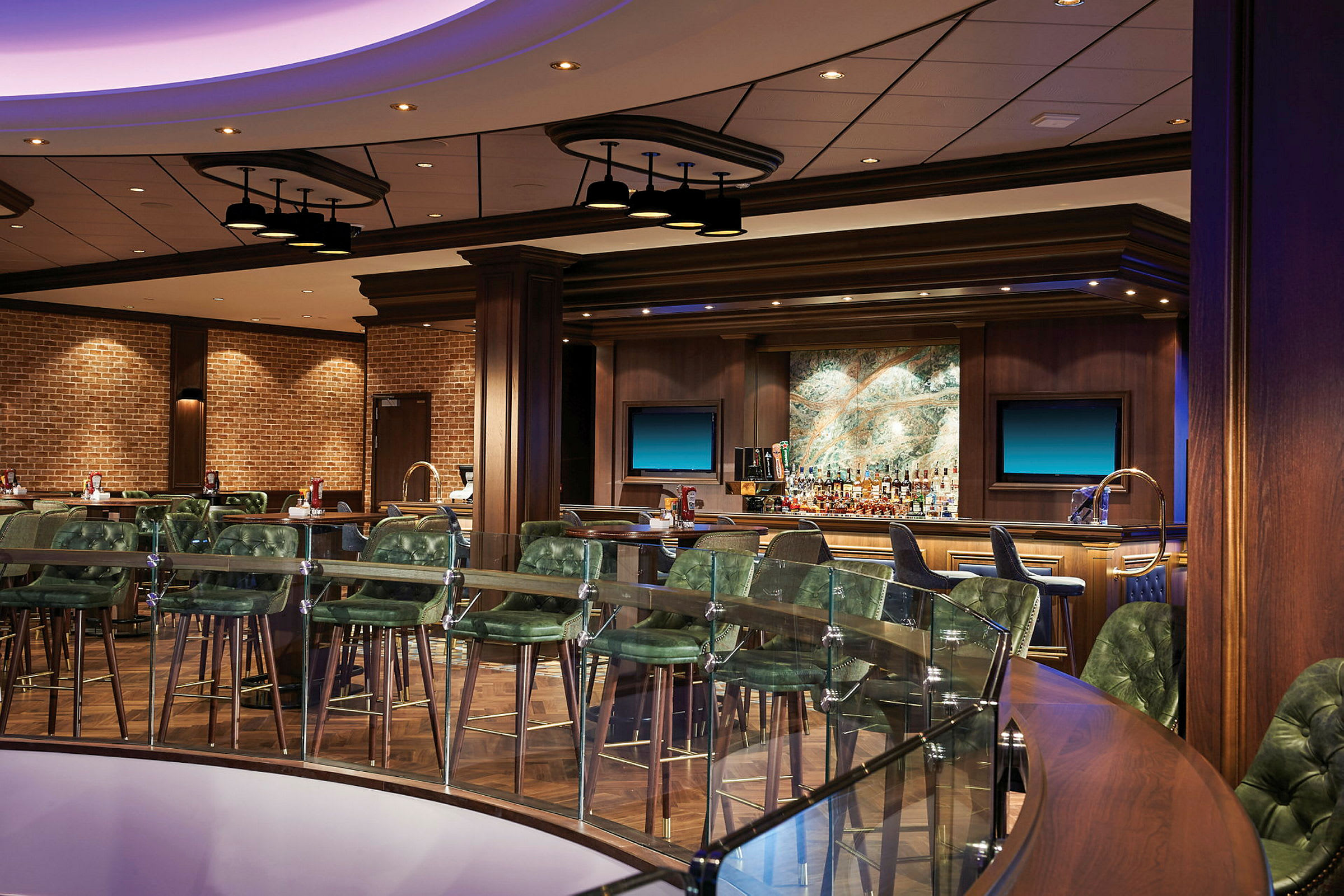 Et billede af en moderne hotelbar med grønne stole og et veludstyret bardiskområde. (AI-genereret tekst)