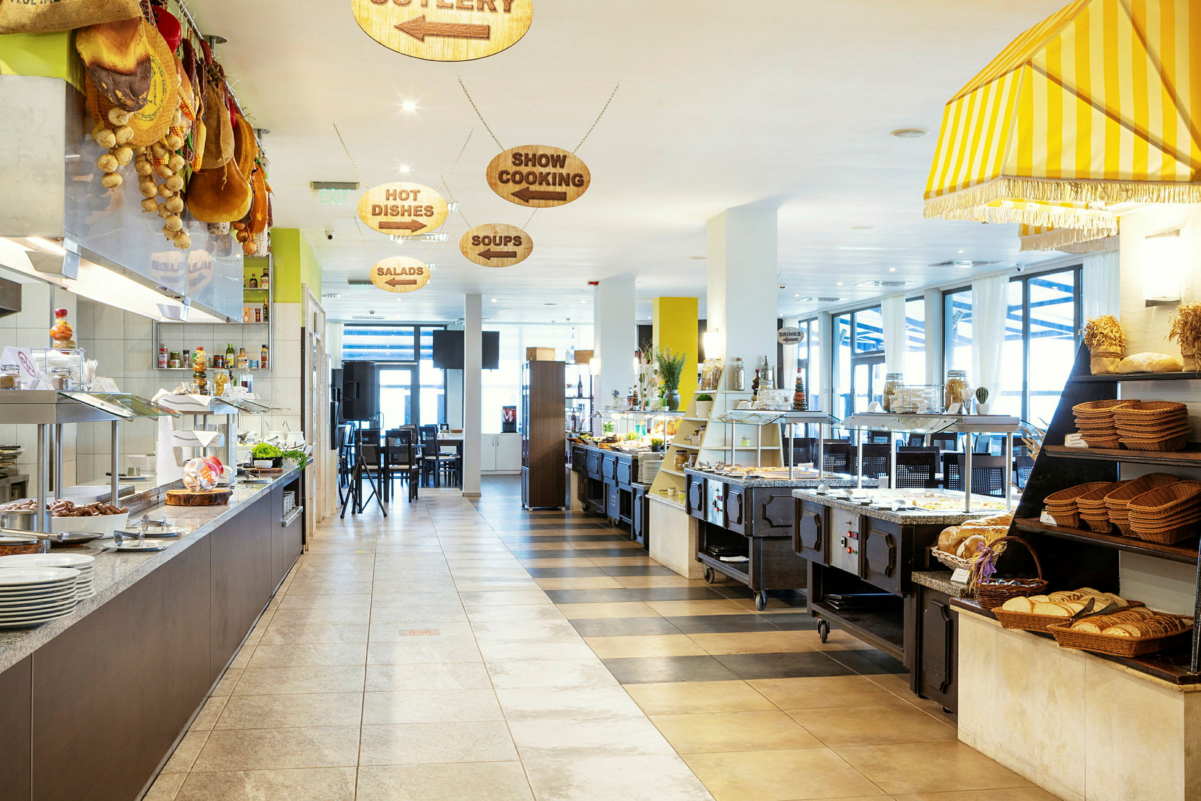 Interiør af en restaurant med en buffet med forskellige retter og brødkurve. (AI-genereret tekst)