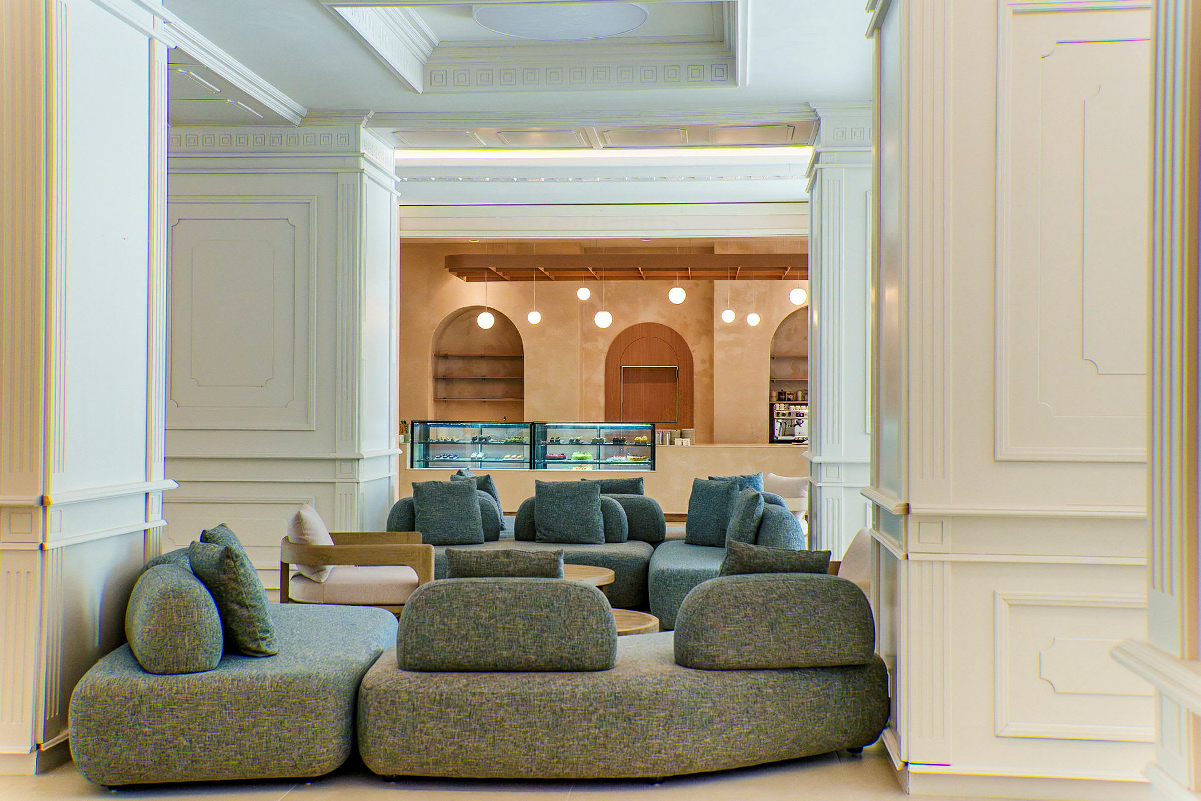 En elegant lounge med bløde sofaer foran en disk med indbygget belysning. (AI-genereret tekst)