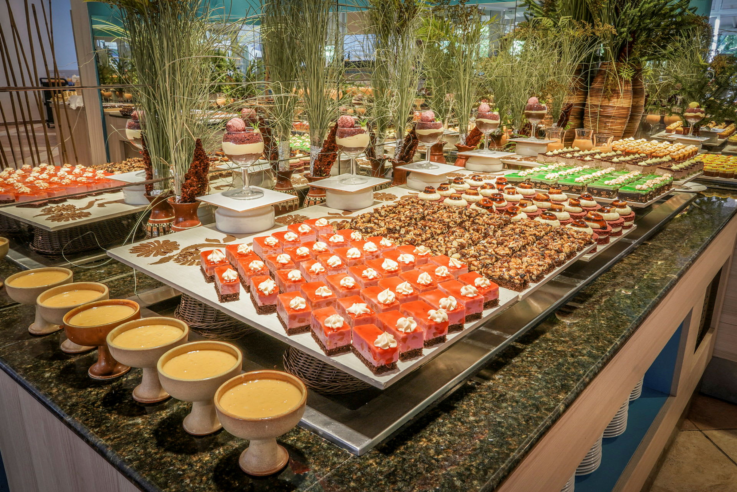 Billede af en buffet med forskellige desserter og bagværk dekoreret og anrettet på et bord. (AI-genereret tekst)