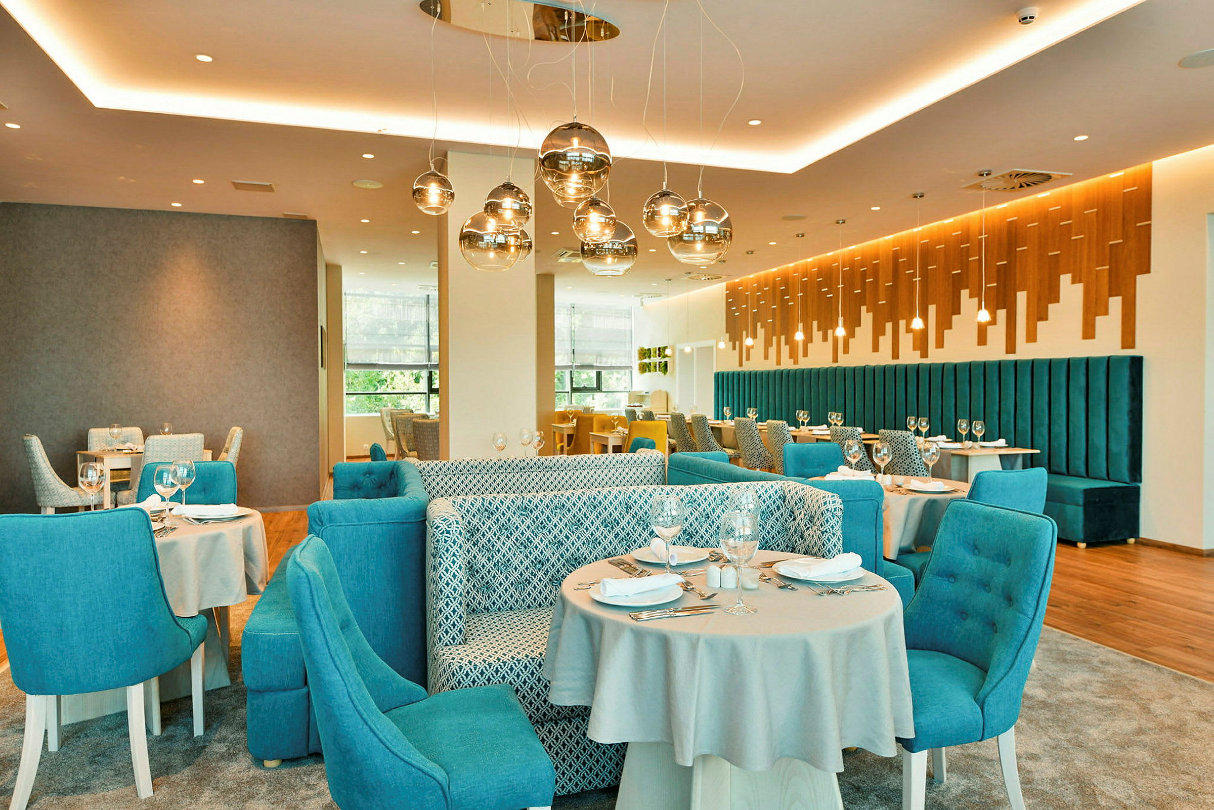 Et moderne restaurantområde med blå stole og elegante borde. (AI-genereret tekst)