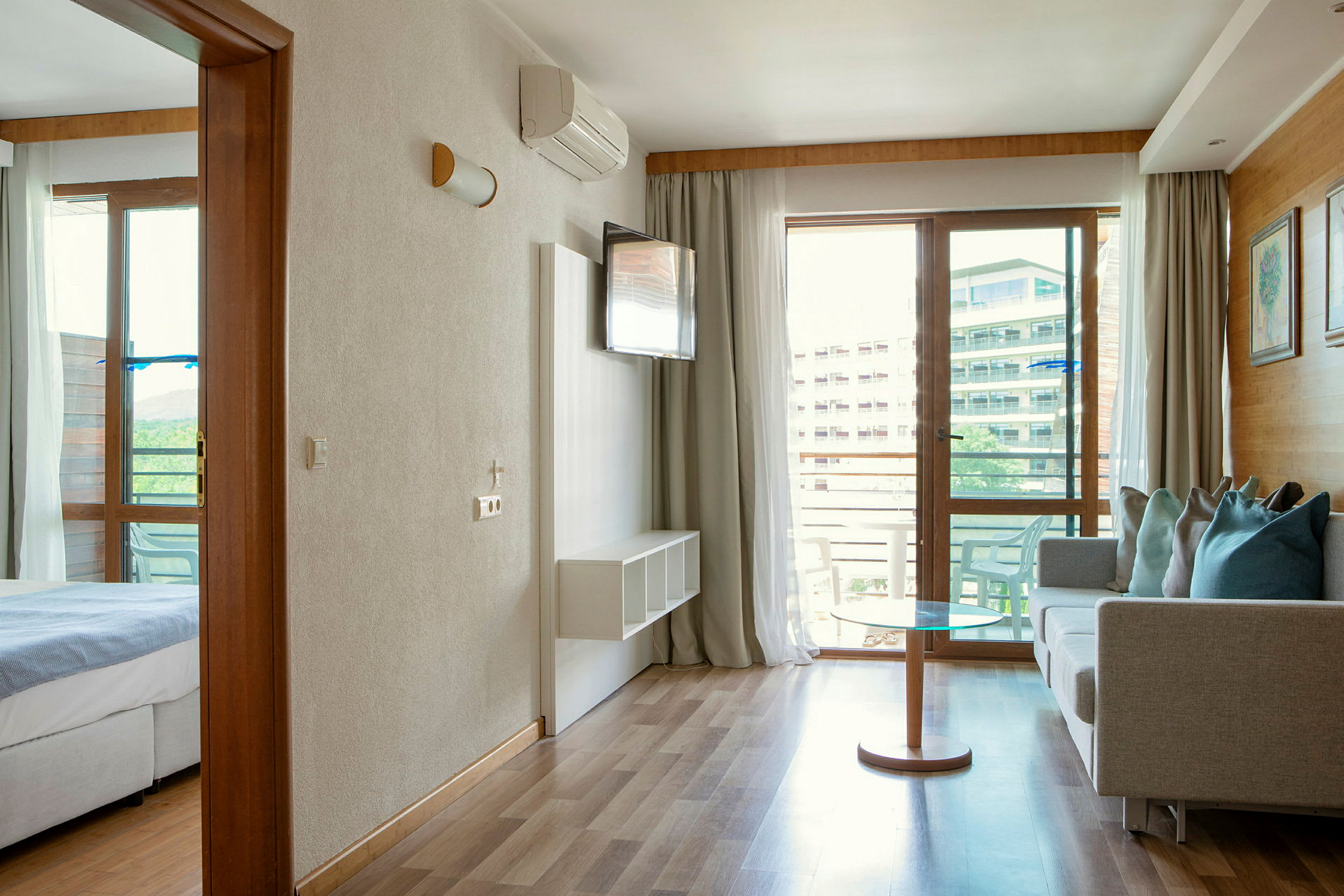 Et hotelværelse med stue og soveværelse samt adgang til en balkon. (AI-genereret tekst)