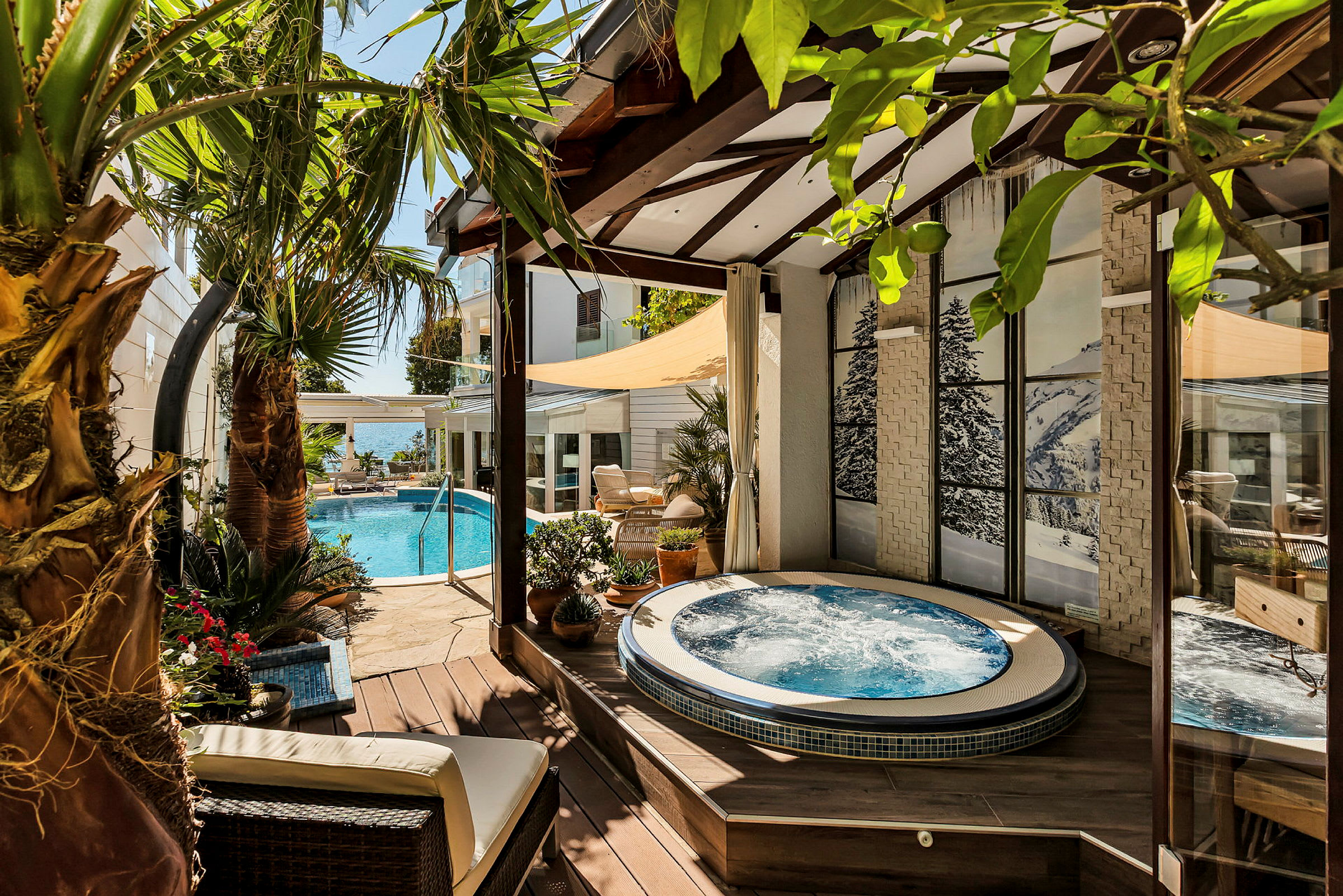 Udendørsområde med jacuzzi, pool og palmer. (AI-genereret tekst)