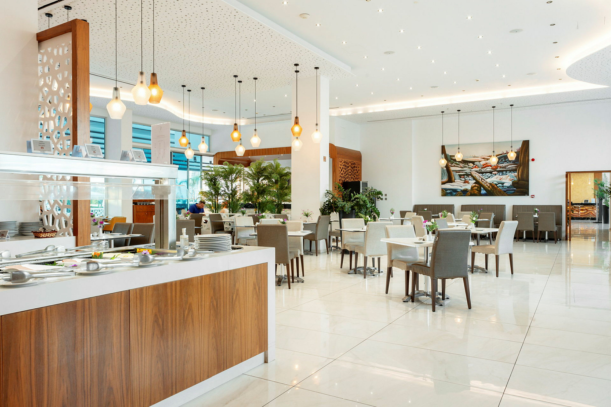 En rummelig og lys restaurant med siddepladser og buffetområde. (AI-genereret tekst)
