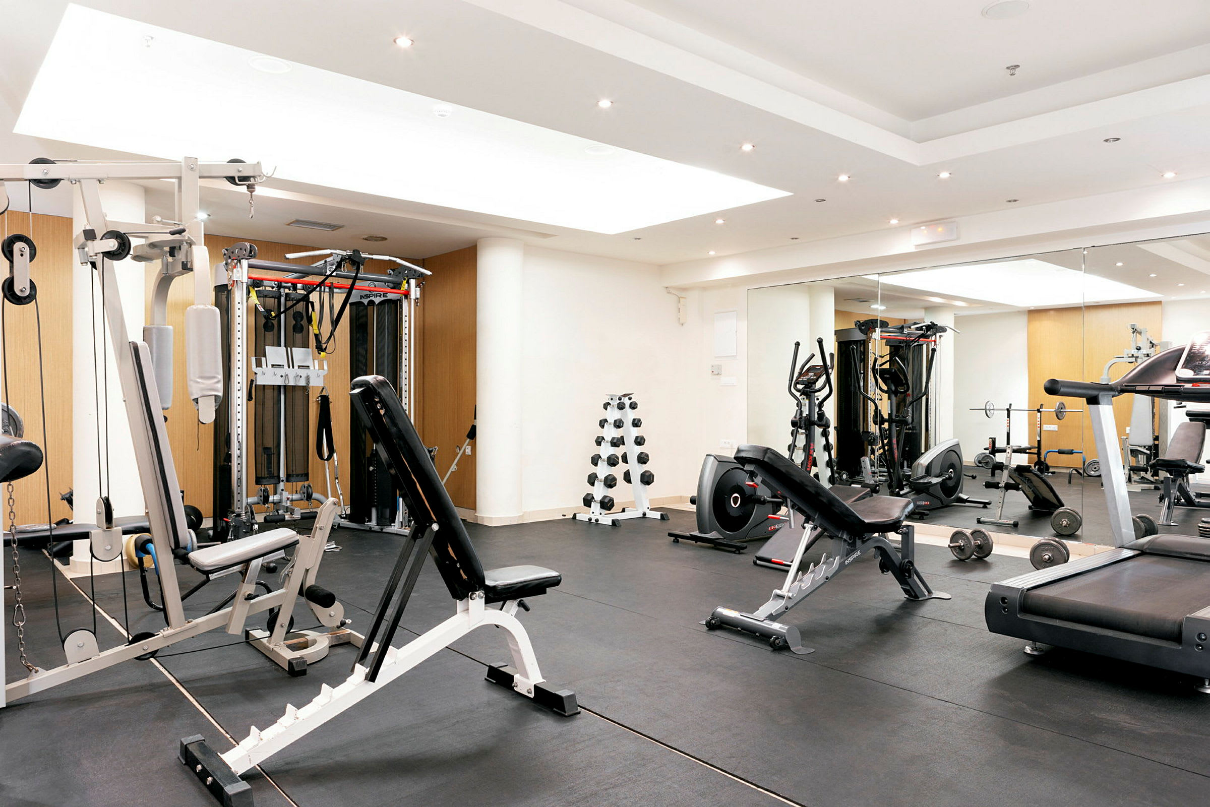 Et moderne fitnesscenter med forskellige træningsmaskiner og frie vægte. (AI-genereret tekst)
