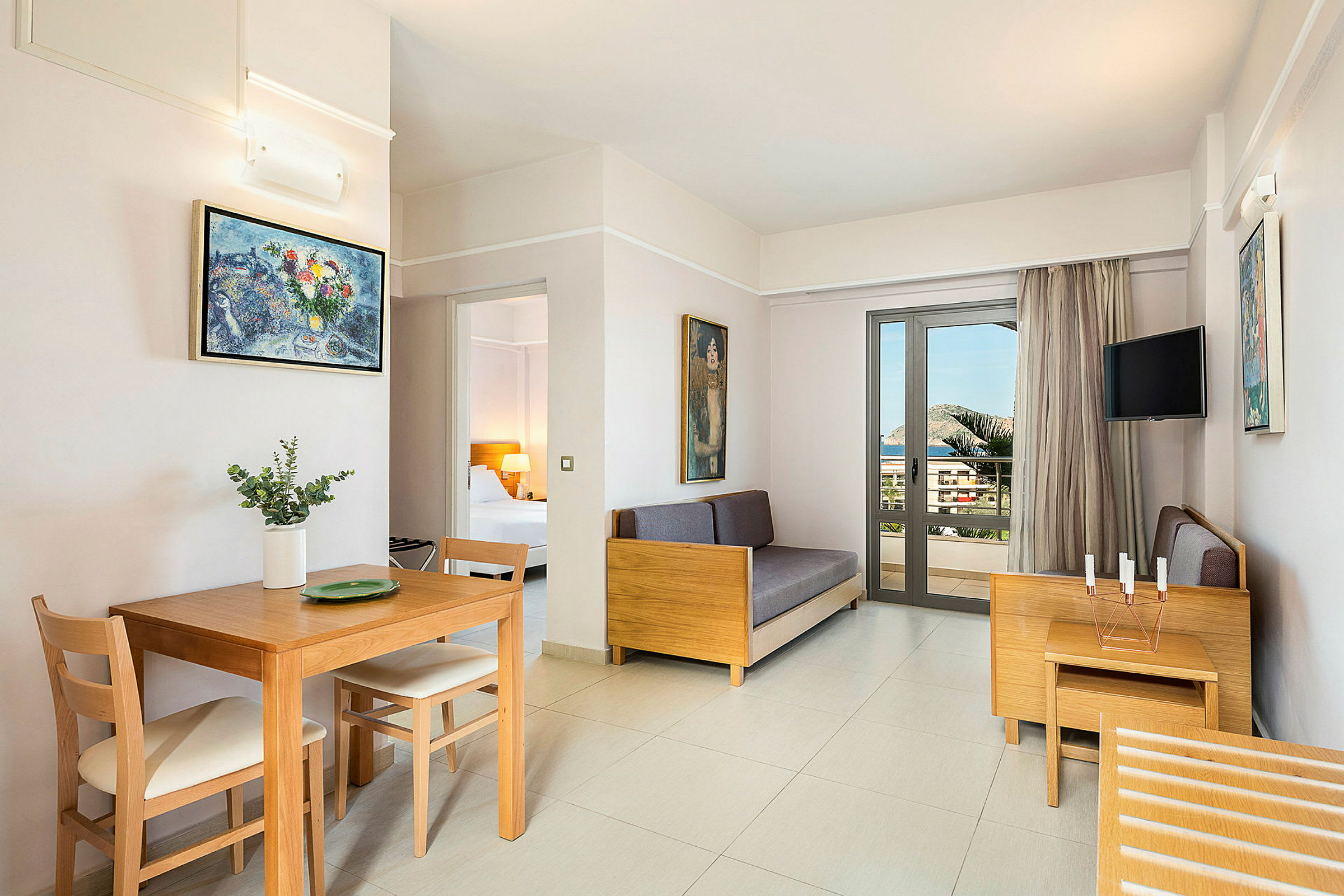 Et moderne hotelværelse med lyse møbler og en balkon. (AI-genereret tekst)