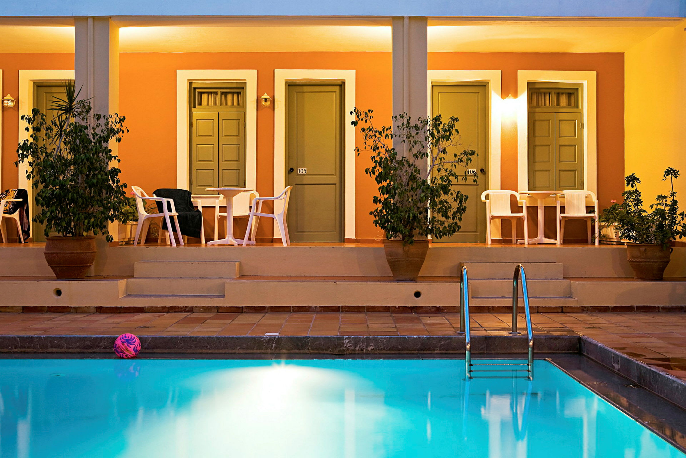 Rækkehuse med verandaer ved en pool. (AI-genereret tekst)