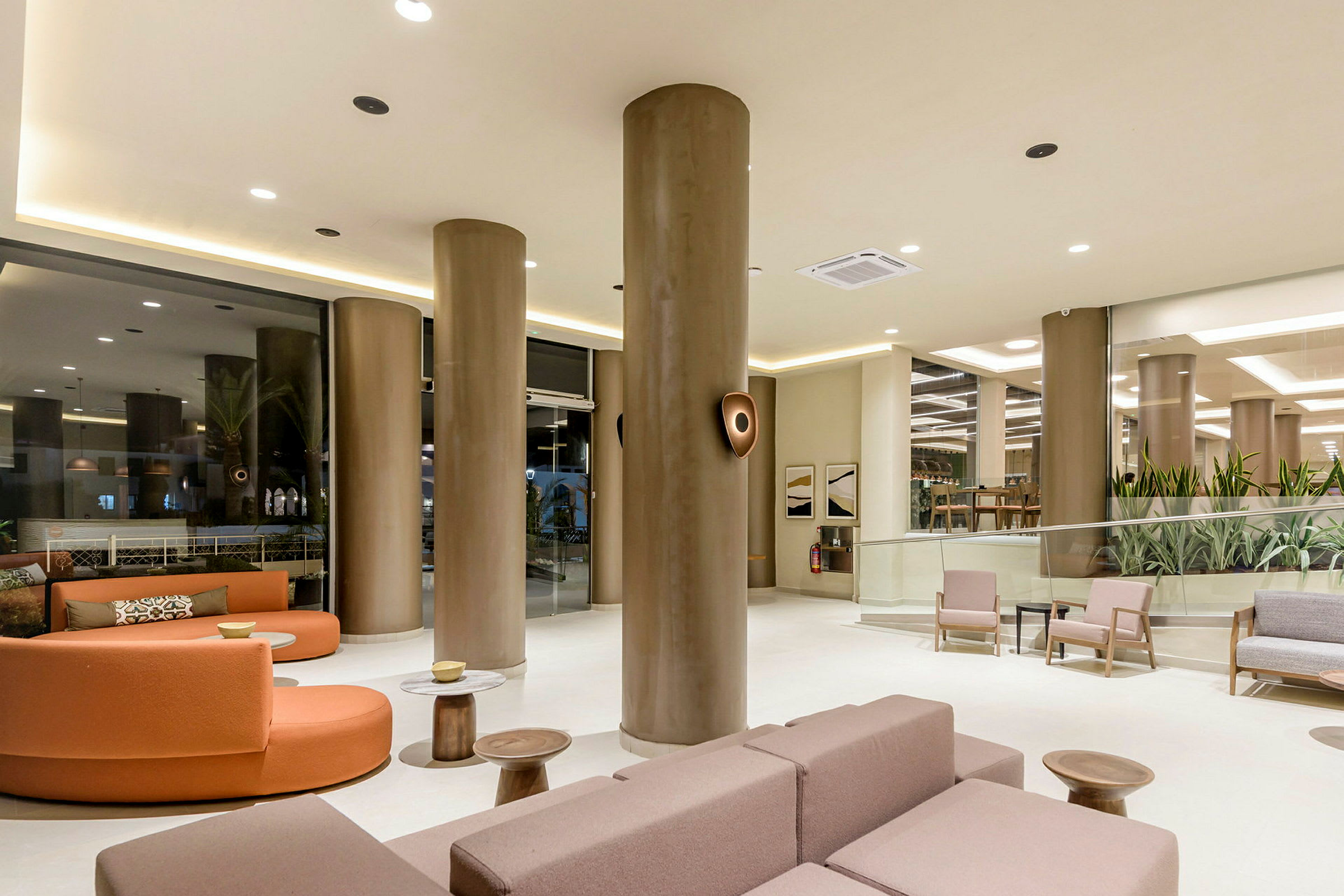 Moderne hotellets lobby med siddeområder og søjler. (AI-genereret tekst)