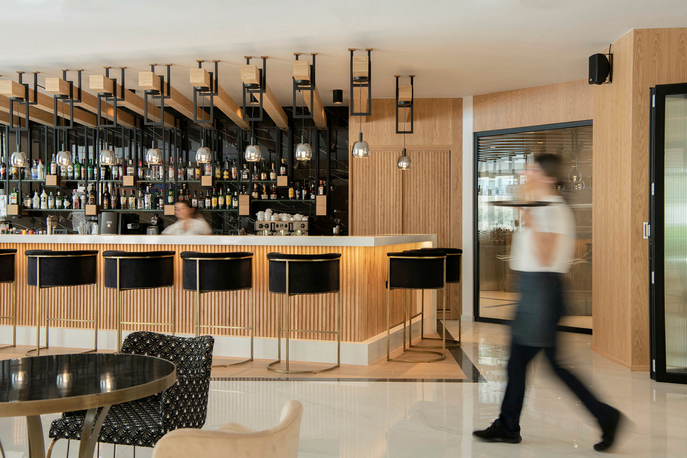 Moderne bar med sorte barstole og træpaneler. (AI-genereret tekst)