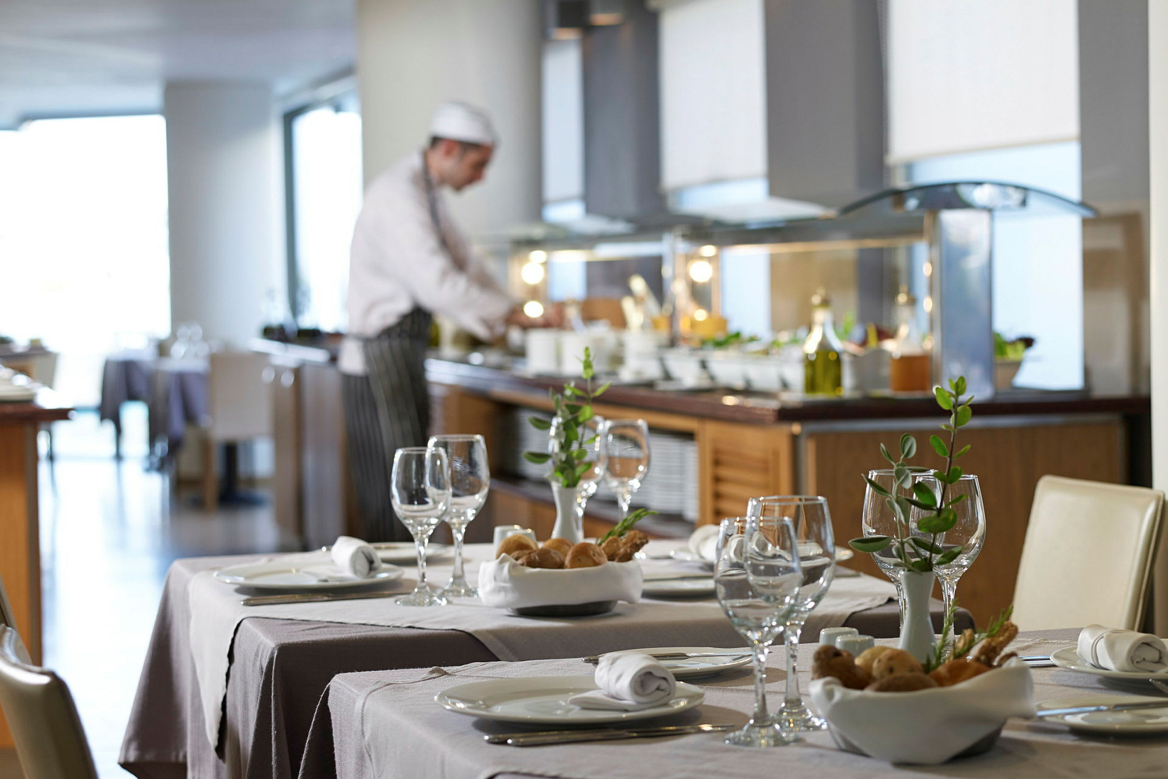 Forretningsrestaurant med elegante dækkede borde og en buffet i baggrunden. (AI-genereret tekst)
