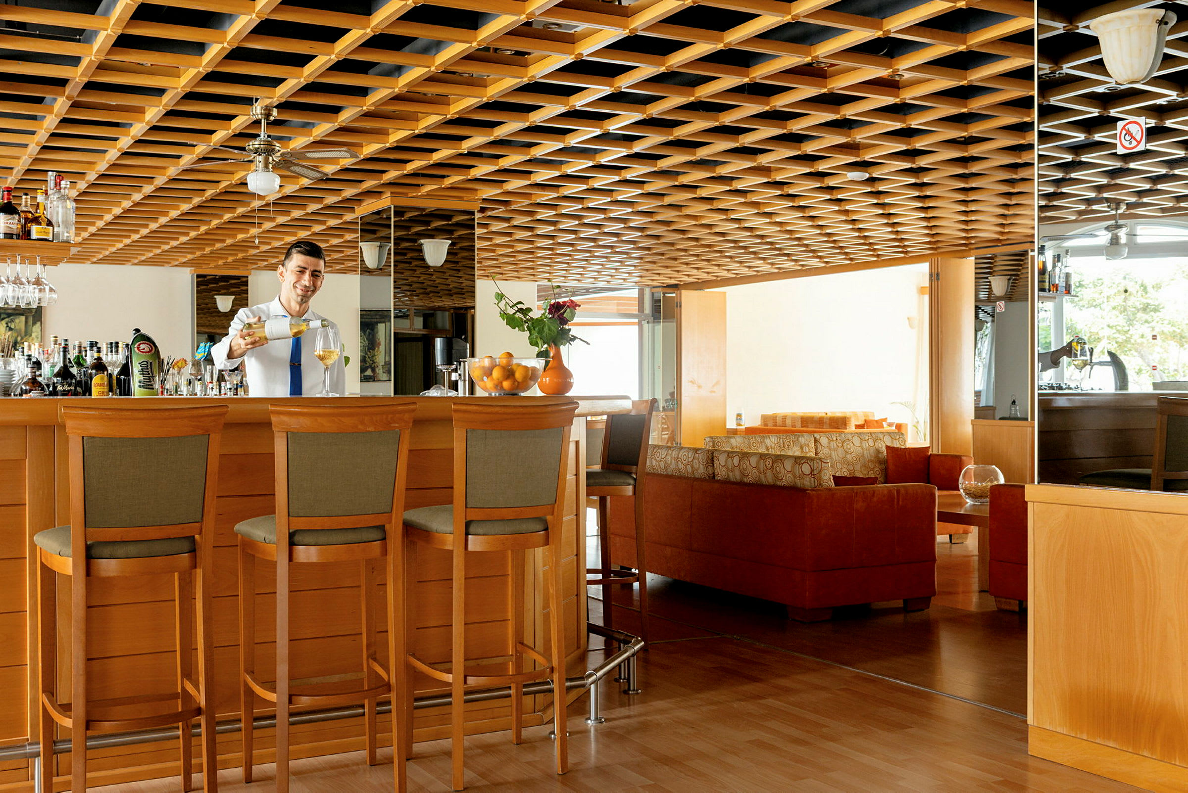 Moderne indrettet hotelbar med trædetaljer og siddeområder. (AI-genereret tekst)