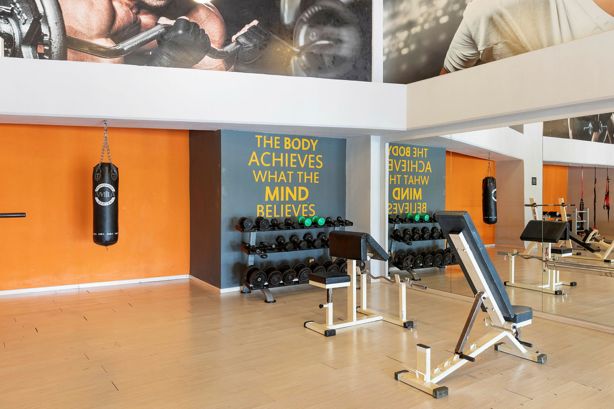 Gym med træningsudstyr og spejlvæg. (AI-genereret tekst)