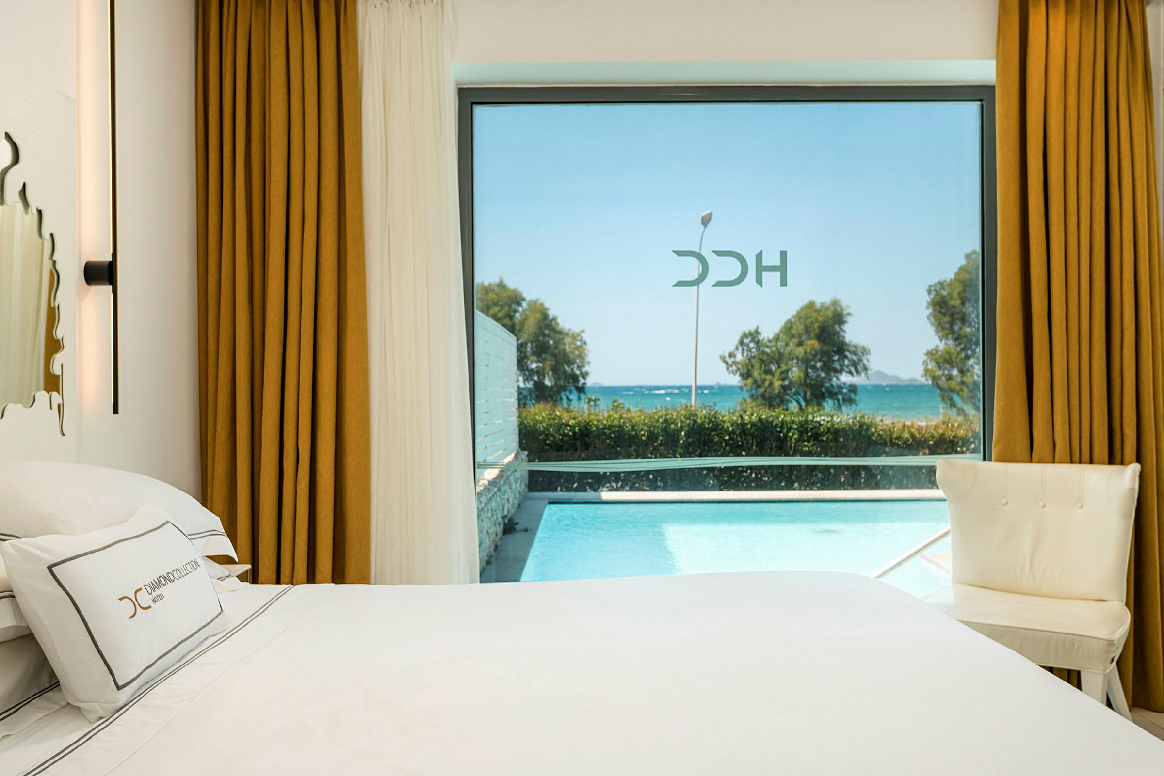 Hotelværelse med udsigt over pool og hav. (AI-genereret tekst)