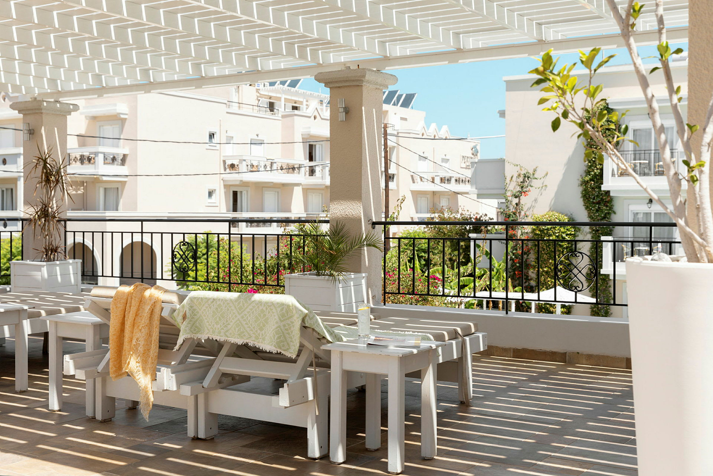 Solterrasse med udsigt over omkringliggende bygninger og beplantning. (AI-genereret tekst)