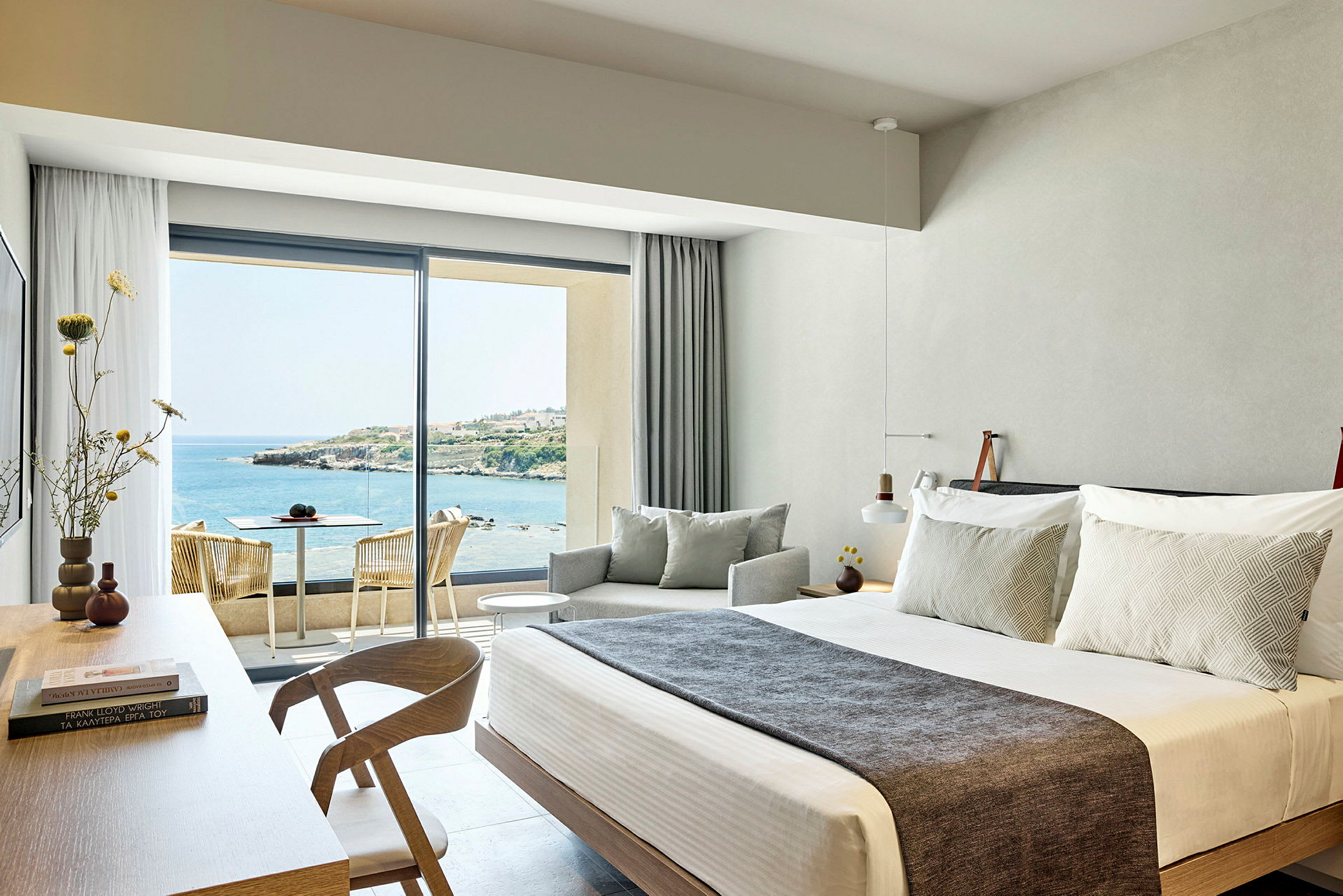 Hotelværelse med moderne indretning og udsigt over havet. (AI-genereret tekst)
